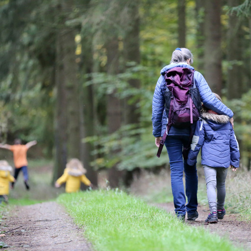 grandmother walking with grandchild out in nature